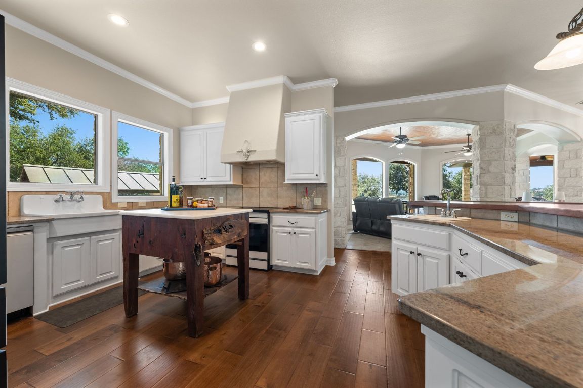185 Shimmering Shore Court Spring Branch, TX 78070 - Photo 14 of 40 a kitchen with a sink cabinets and wooden floor