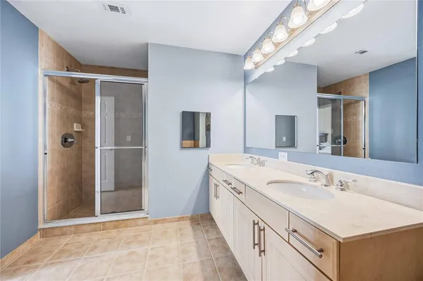 a spacious bathroom with a double vanity sink mirror and double