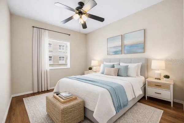 a bedroom with a large bed and a window