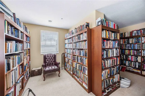 a reading room with furniture book shelf and a book shelf