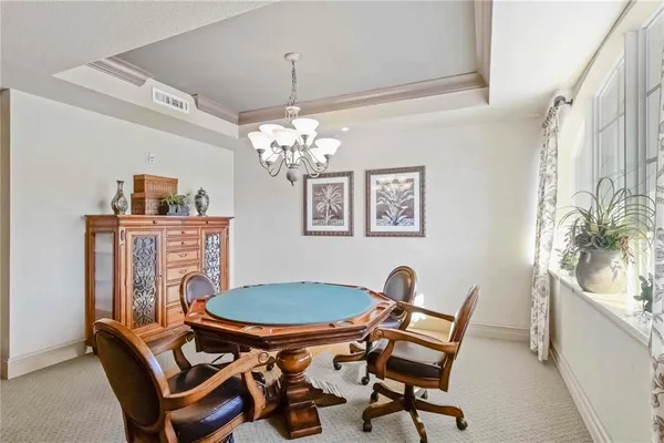 a dining room with furniture and chandelier