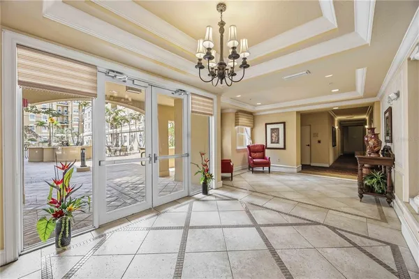 a lobby with furniture and a chandelier