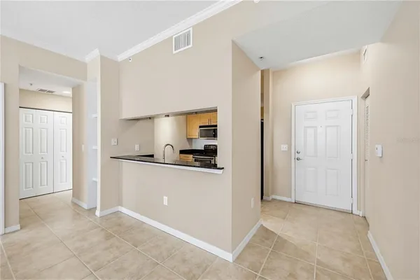 a kitchen with white cabinets and refrigerator