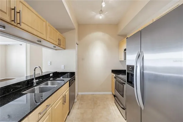 a kitchen that has a sink and stainless steel appliances