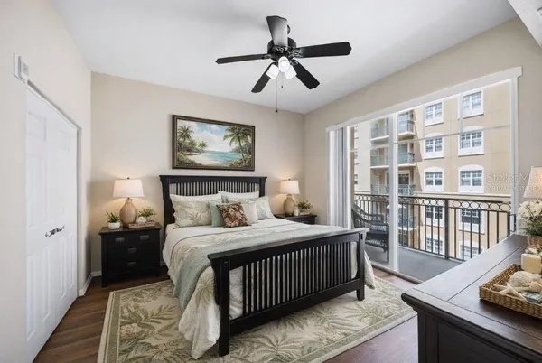 a bedroom with a bed and wooden floor
