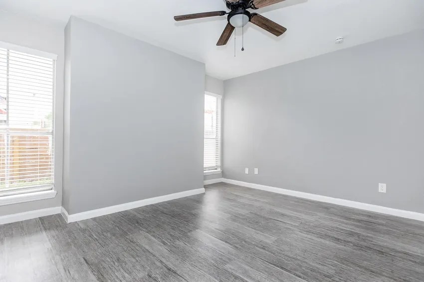 4400 Memorial Drive, Unit 43066 Houston, TX 77007 - Photo 17 of 20 an empty room with wooden floor fan and windows