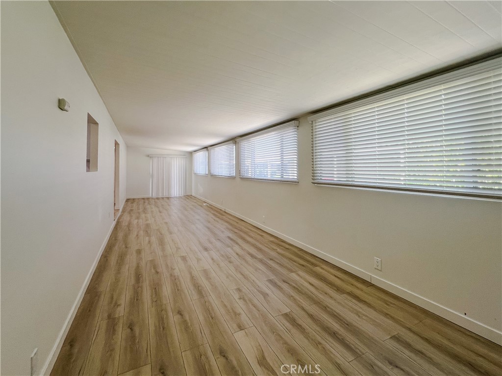 1245 West Cienega Avenue San Dimas, CA 91773 - Photo 12 of 14 a view of an empty room with wooden floor and a window