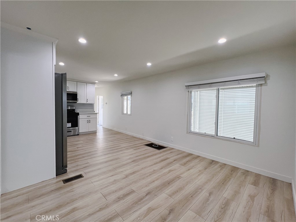 1245 West Cienega Avenue San Dimas, CA 91773 - Photo 5 of 14 an empty room with wooden floor and windows