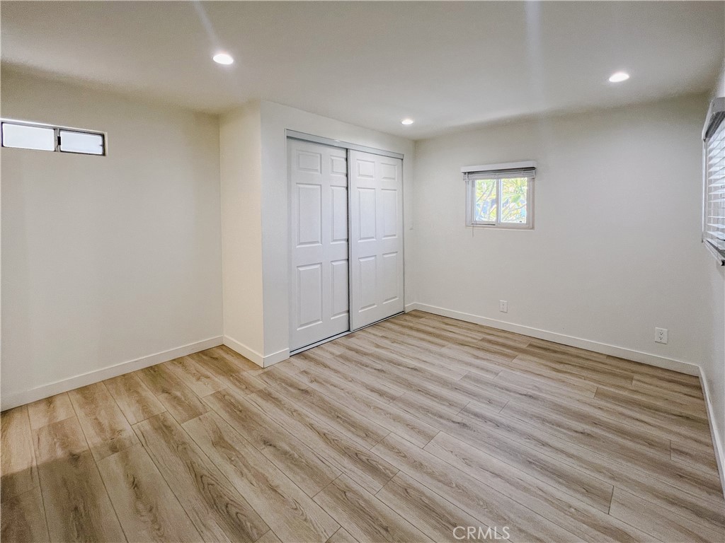 1245 West Cienega Avenue San Dimas, CA 91773 - Photo 6 of 14 an empty room with wooden floor and windows