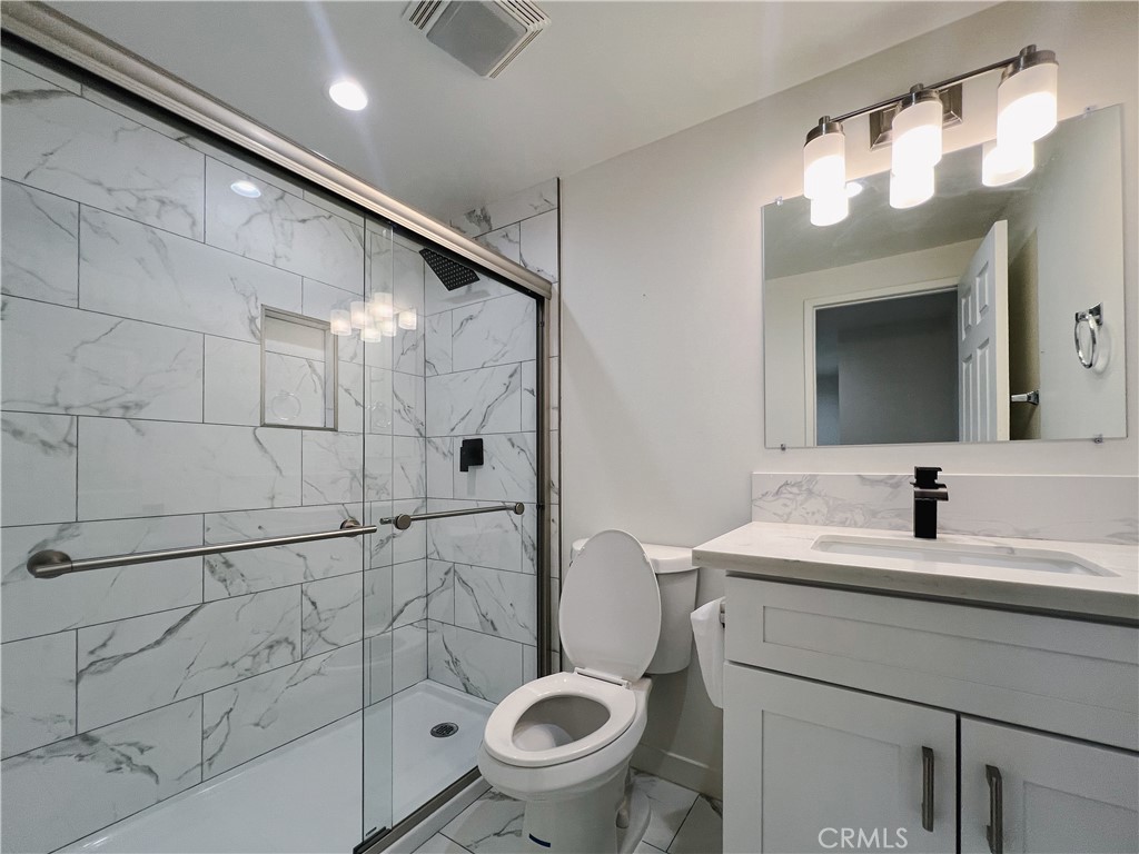 1245 West Cienega Avenue San Dimas, CA 91773 - Photo 9 of 14 a bathroom with a sink a toilet and shower