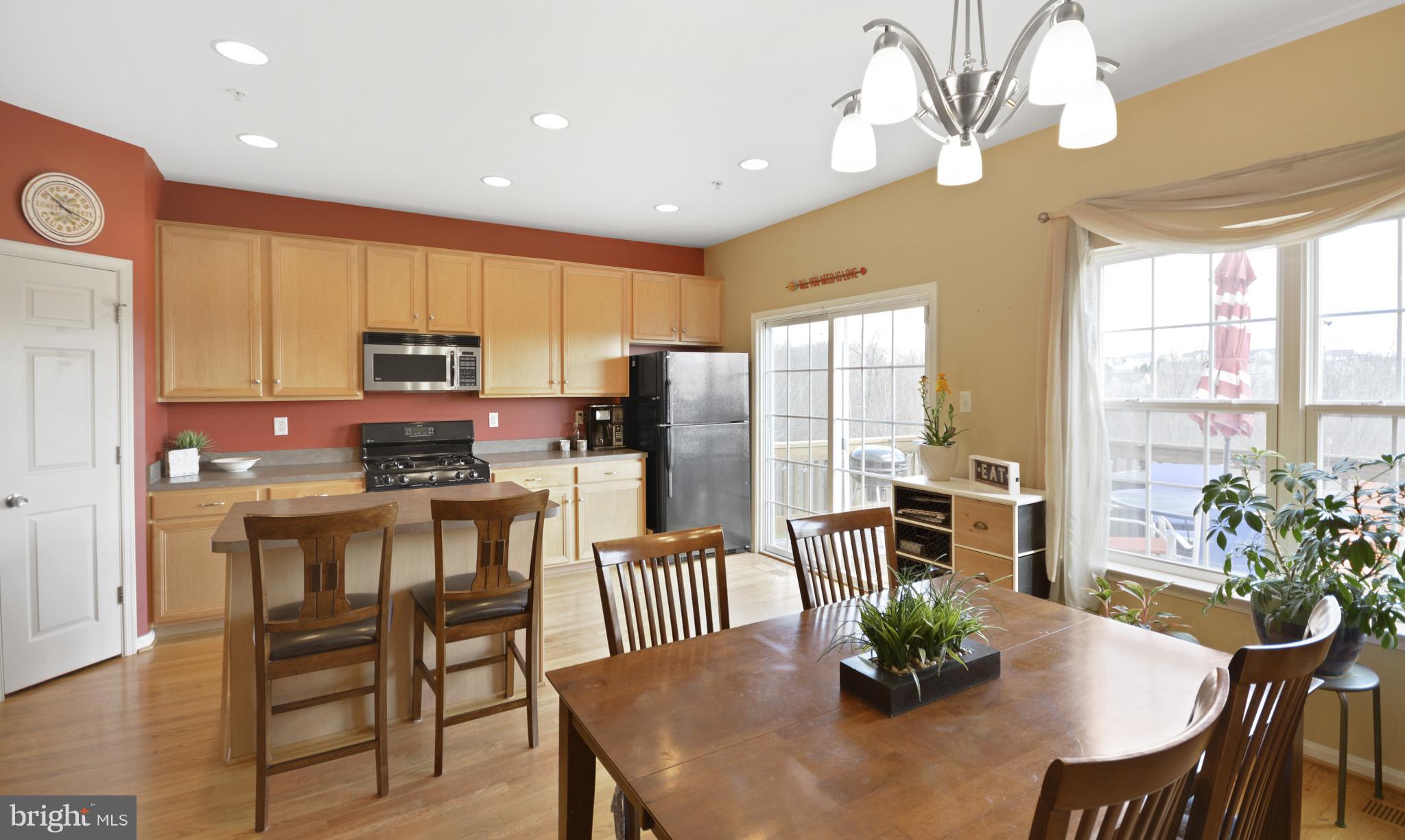 1741 Trestle Street Mount Airy, MD 21771 - Photo 5 of 30 a kitchen with a table chairs refrigerator and microwave