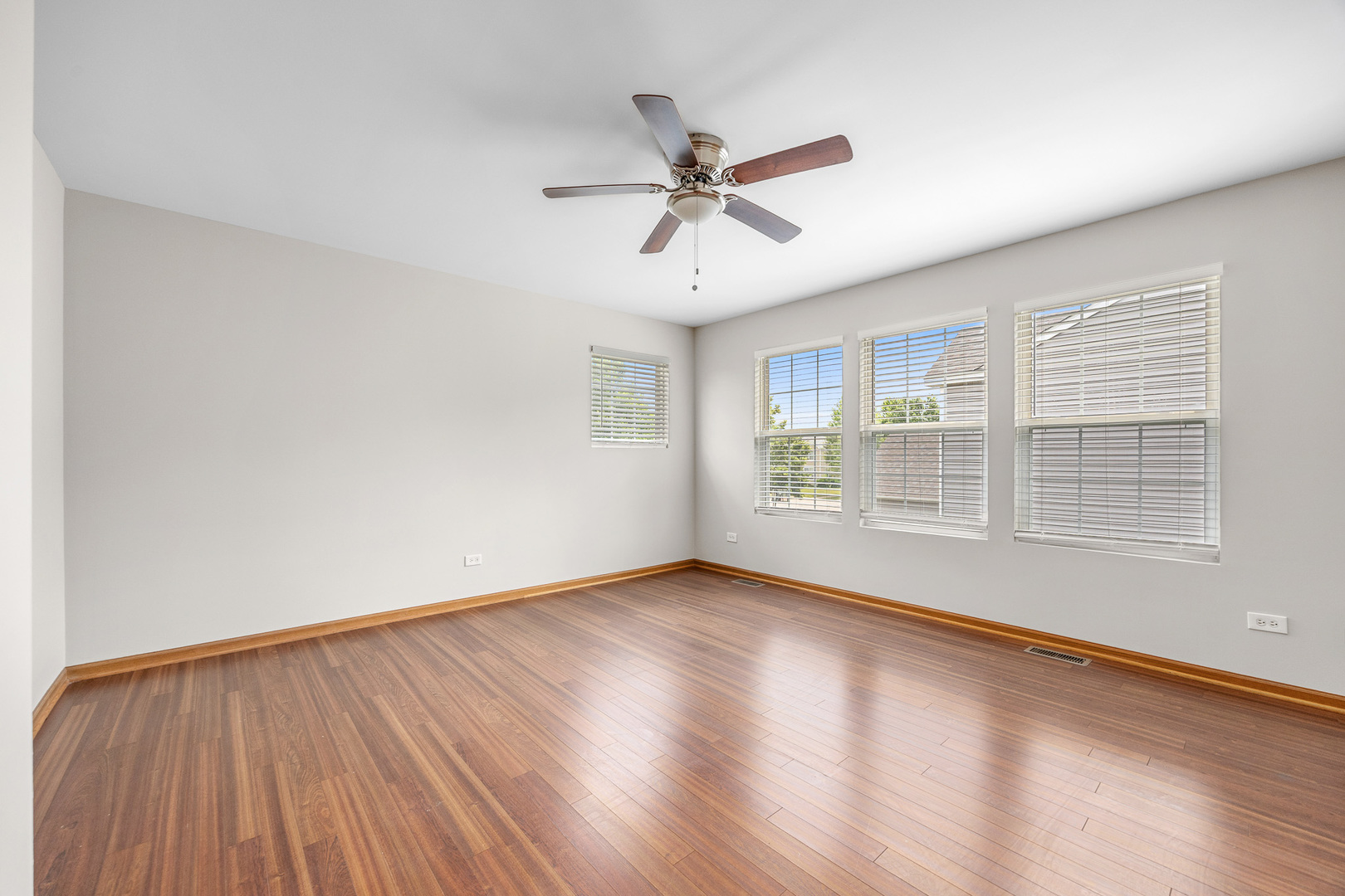 1301 Bridgehampton Drive Plainfield, IL 60586 - Photo 18 of 34 a view of empty room with wooden floor and fan