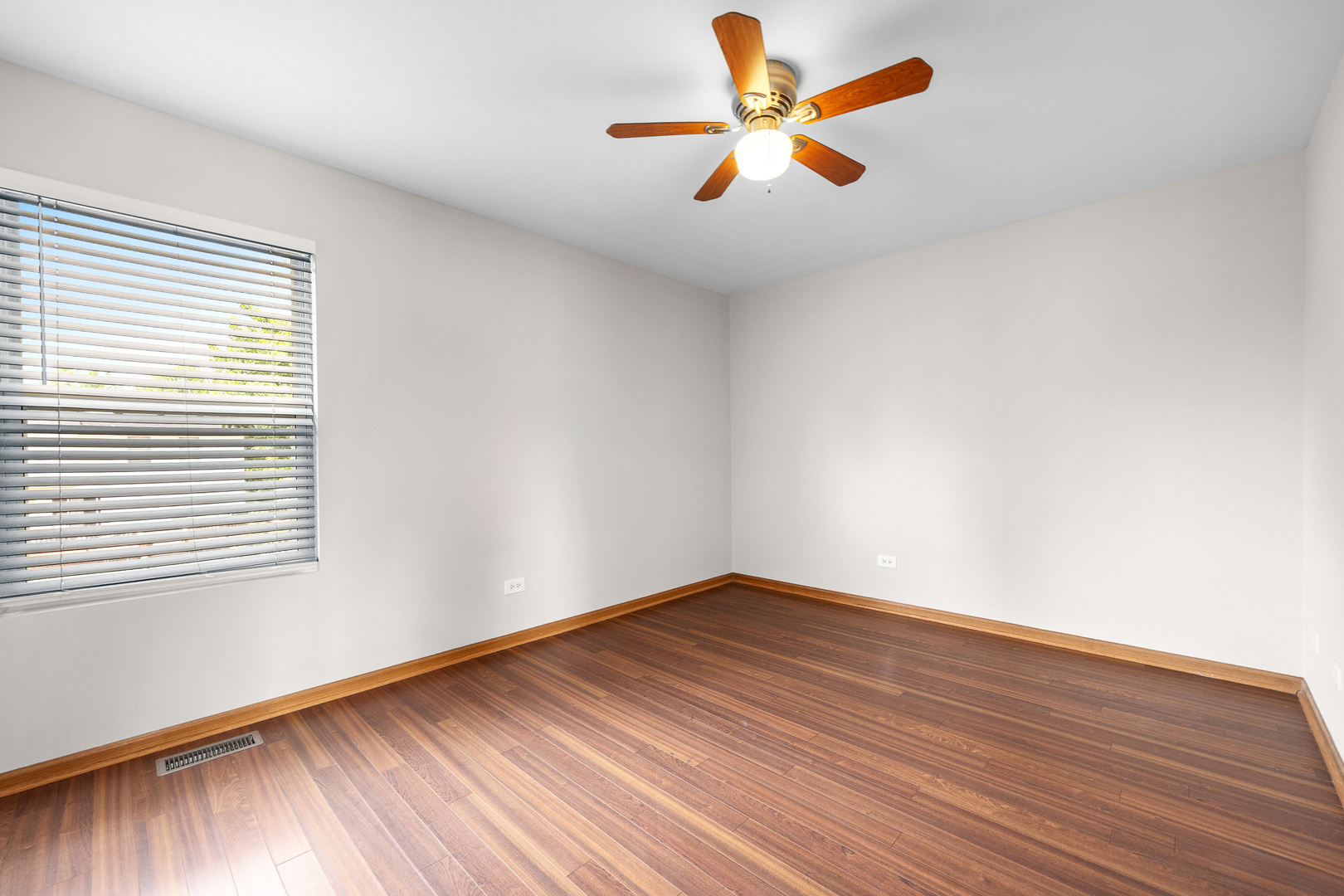 1301 Bridgehampton Drive Plainfield, IL 60586 - Photo 25 of 34 an empty room with wooden floor and windows