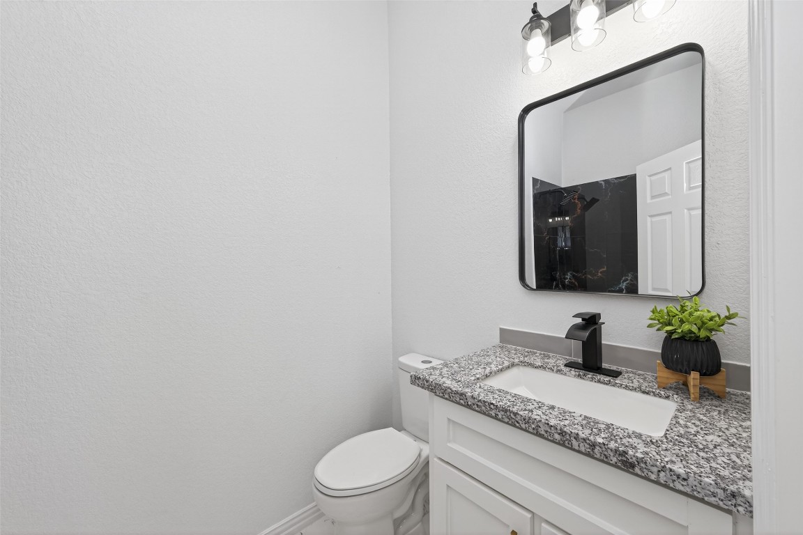 1105 Peter Pne Street Huffman, TX 77336 - Photo 34 of 41 a bathroom with a granite countertop toilet sink and mirror