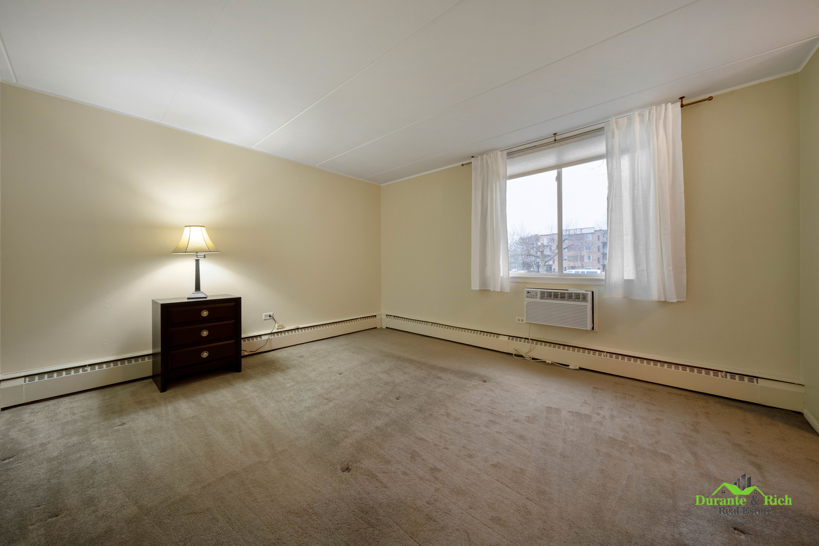 225 South Rohlwing Road, Unit 118 Palatine, IL 60074 - Photo 7 of 12 an empty room with a empty space and a window