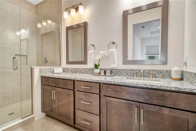 a bathroom with a granite countertop sink double and mirror