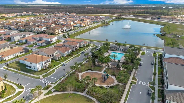 an aerial view of residential houses with outdoor space