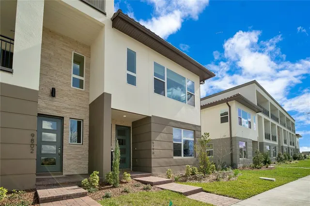 a view of a white building among the yard