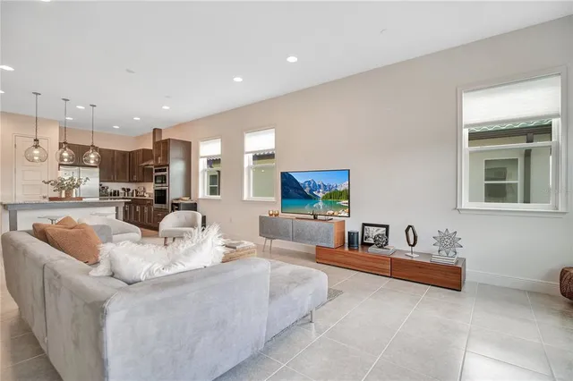 a view of a living room kitchen and a large window