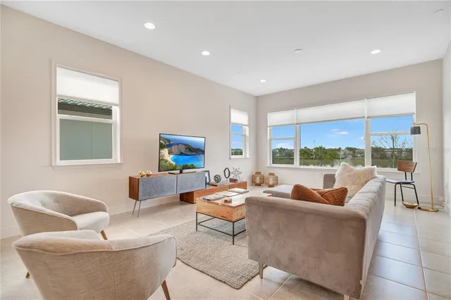 a living room with furniture and a large window