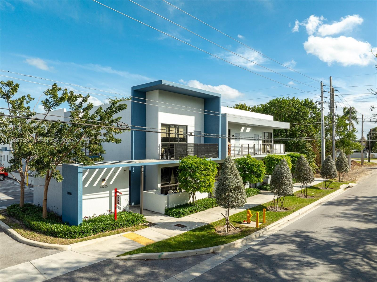 24705 Southwest 129th Avenue, Unit 108 Homestead, FL 33032 - Photo 31 of 33 a front view of a house with garden