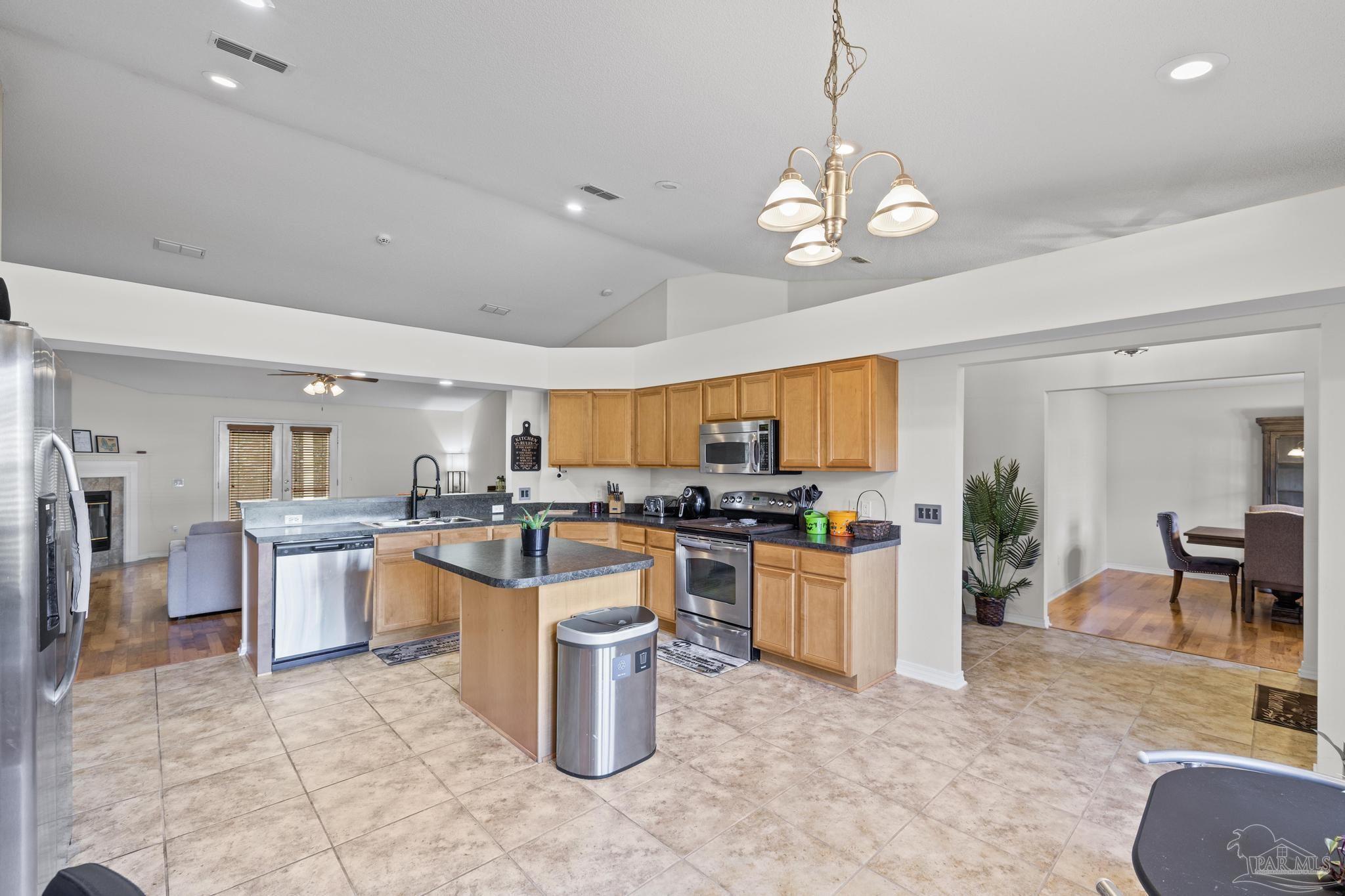 2165 Liberty Loop Road Cantonment, FL 32533 - Photo 21 of 51 a kitchen with a large counter top space appliances and cabinets