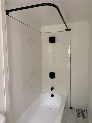 a bathroom with a tub and a shower