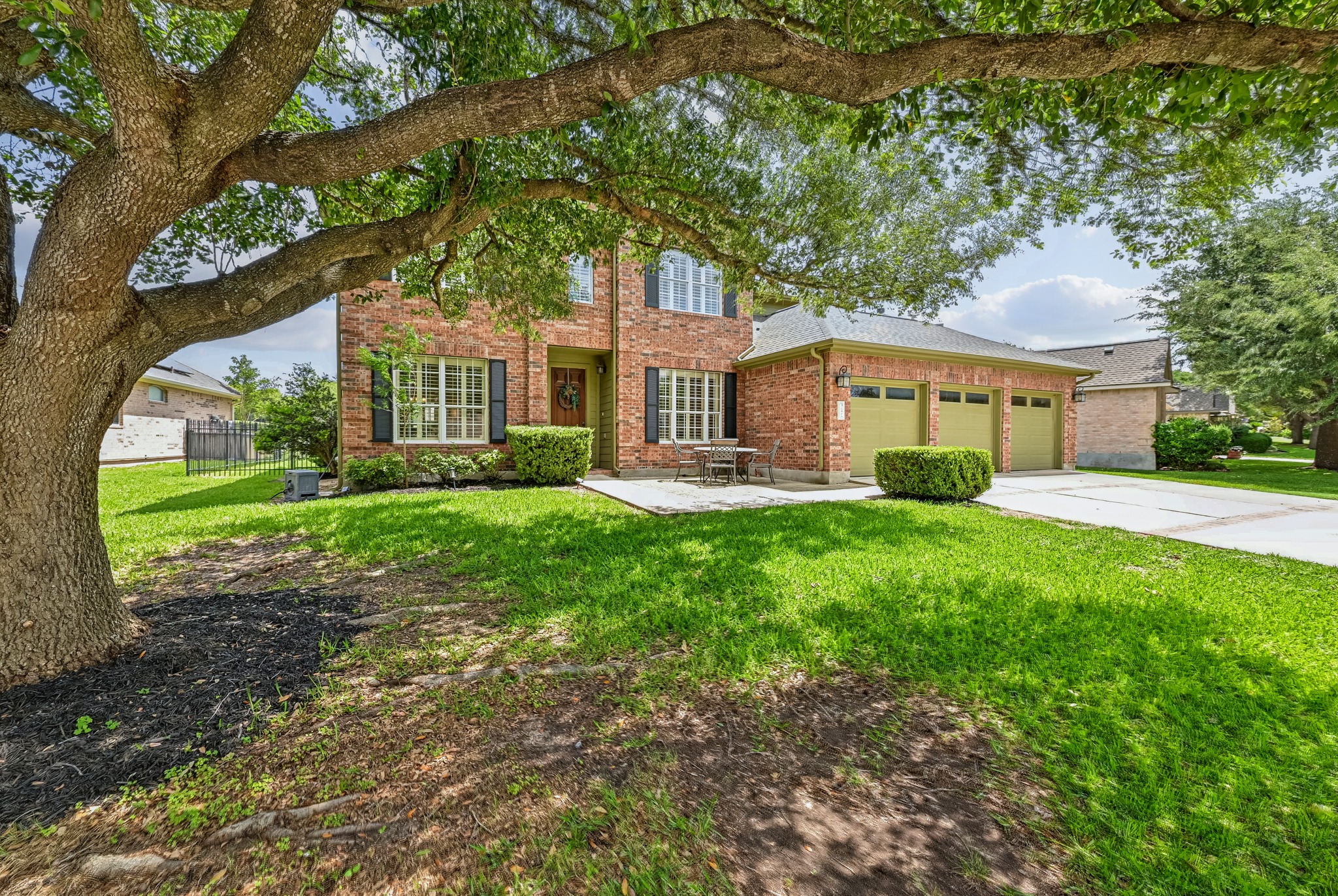 2408 Amen Corner Road Pflugerville, TX 78660 - Photo 1 of 40 Brick two-story residence with a three-car garage featuring individual garage doors