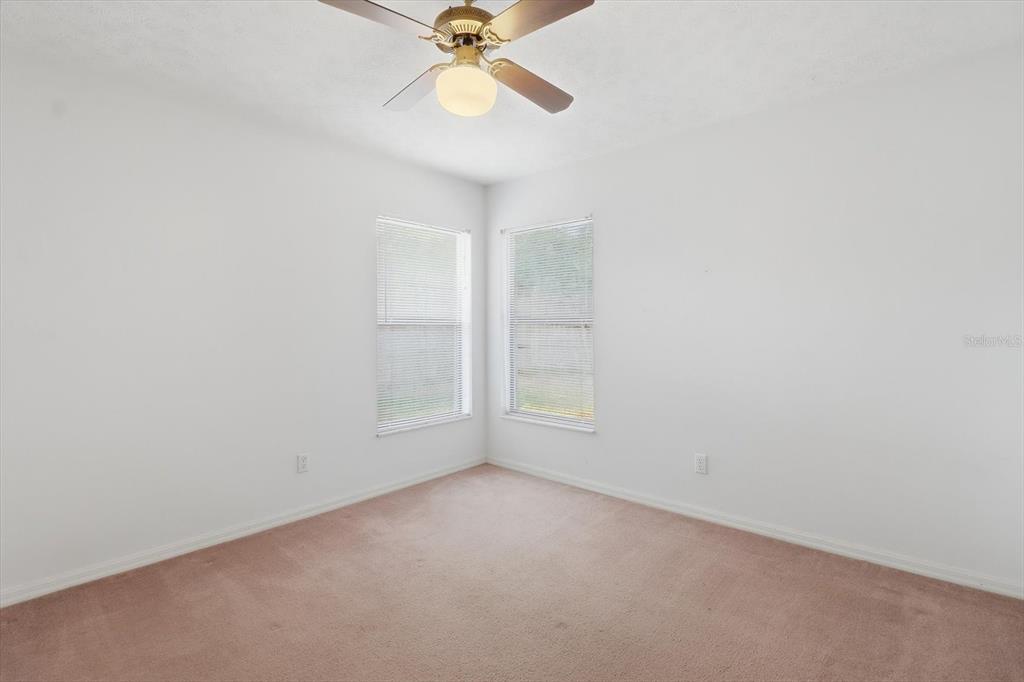 6355 East Rush Street Inverness, FL 34452 - Photo 18 of 27 an empty room with windows and fan