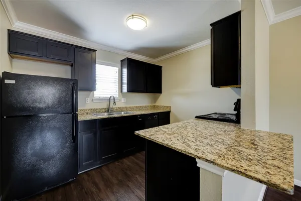 a kitchen with a sink refrigerator and microwave