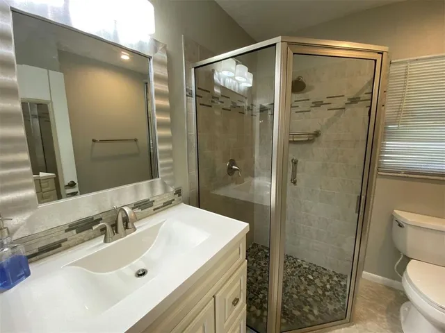a bathroom with a sink toilet and shower