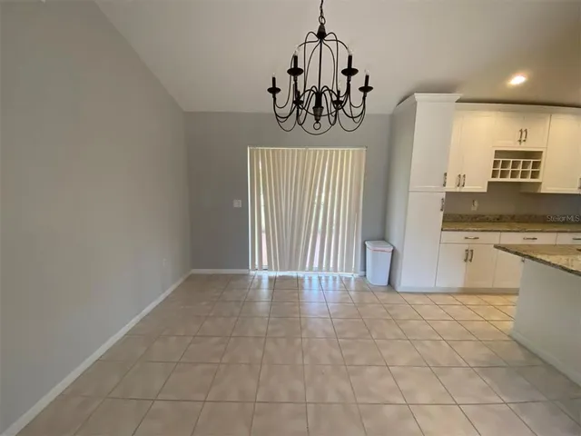 a view of a kitchen with a sink and dishwasher with wooden floor