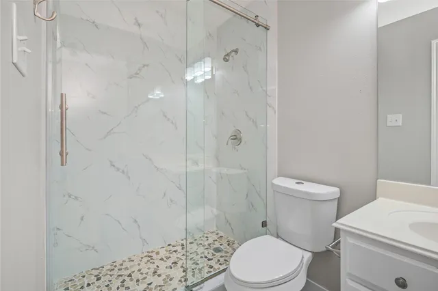 a white toilet sitting next to a shower curtain