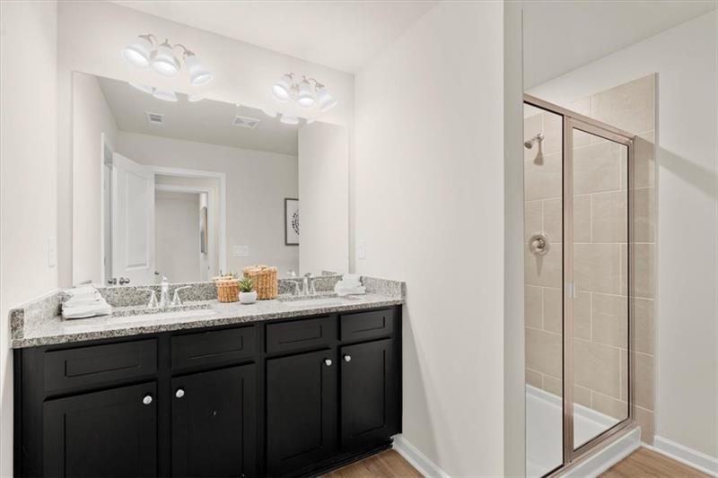 939 Elwood Street Dacula, GA 30019 - Photo 14 of 22 a bathroom with a double vanity sink and mirror