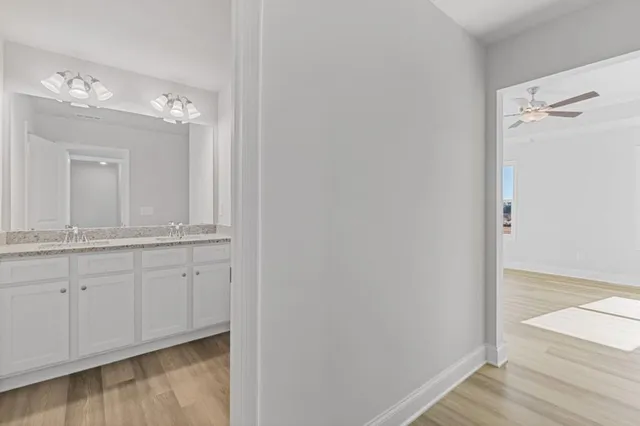 a bathroom with a double vanity sink and mirror