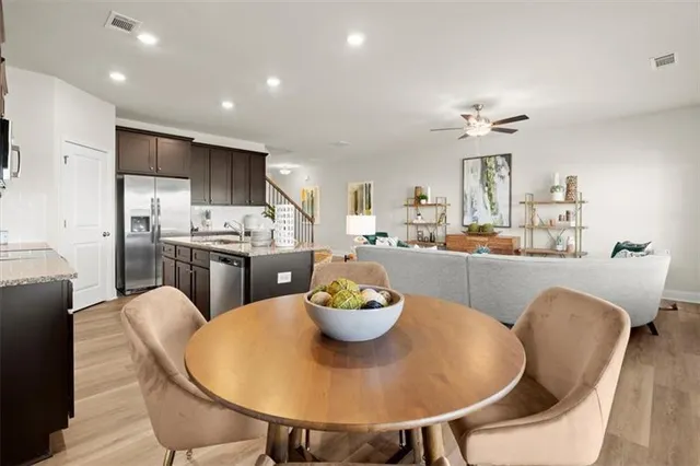 a kitchen with a dining table and chairs