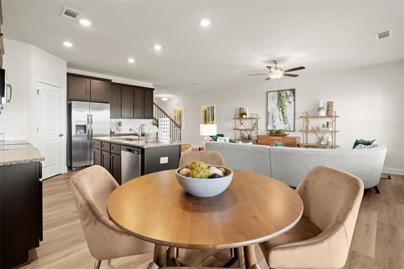 939 Elwood Street Dacula, GA 30019 - Photo 9 of 22 a kitchen with a dining table and chairs