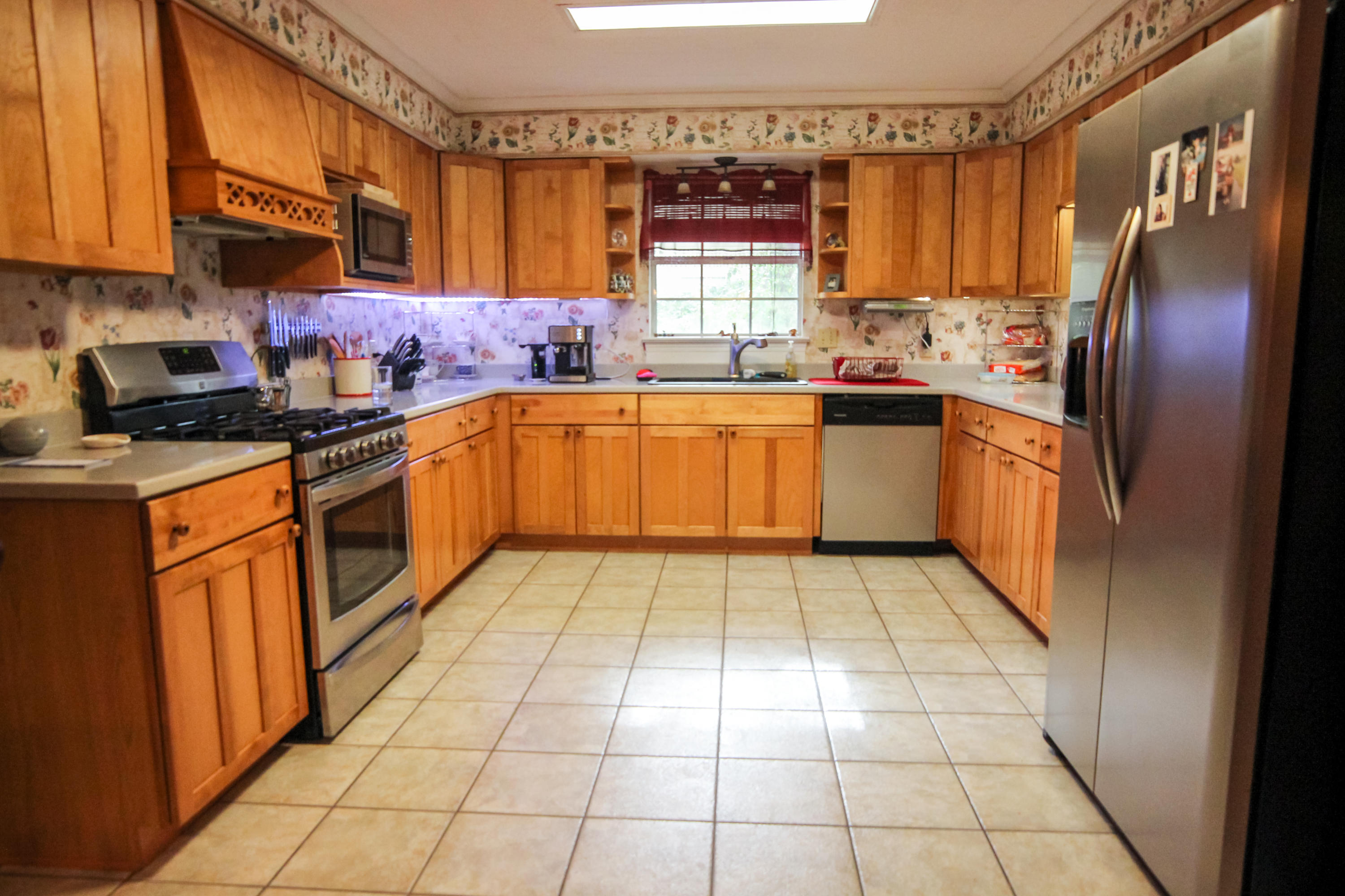 32 Country Club Road Shalimar, FL 32579 - Photo 13 of 56 a kitchen with stainless steel appliances granite countertop a stove a sink and a microwave