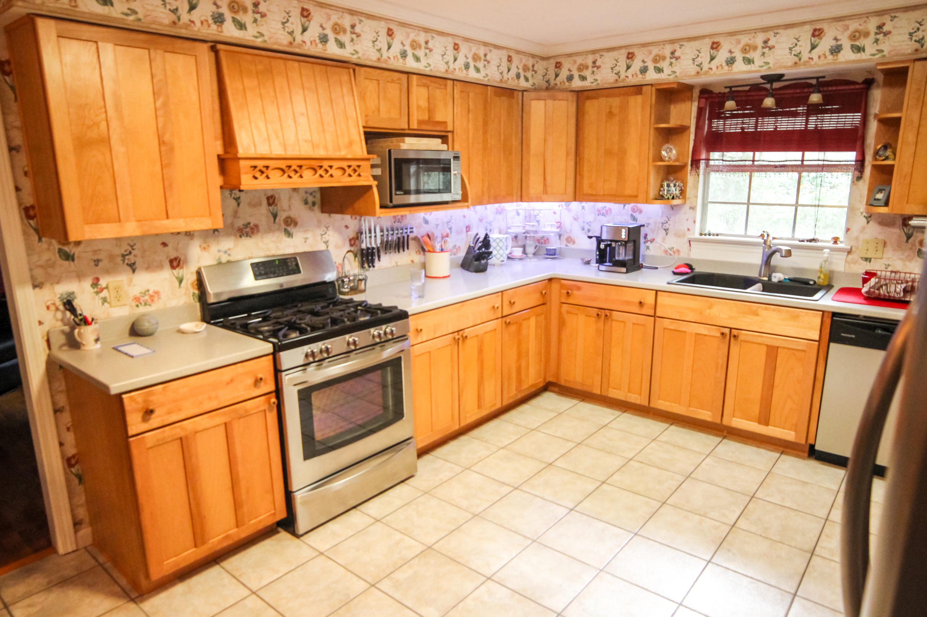 32 Country Club Road Shalimar, FL 32579 - Photo 14 of 56 a kitchen with stainless steel appliances a stove sink and cabinets