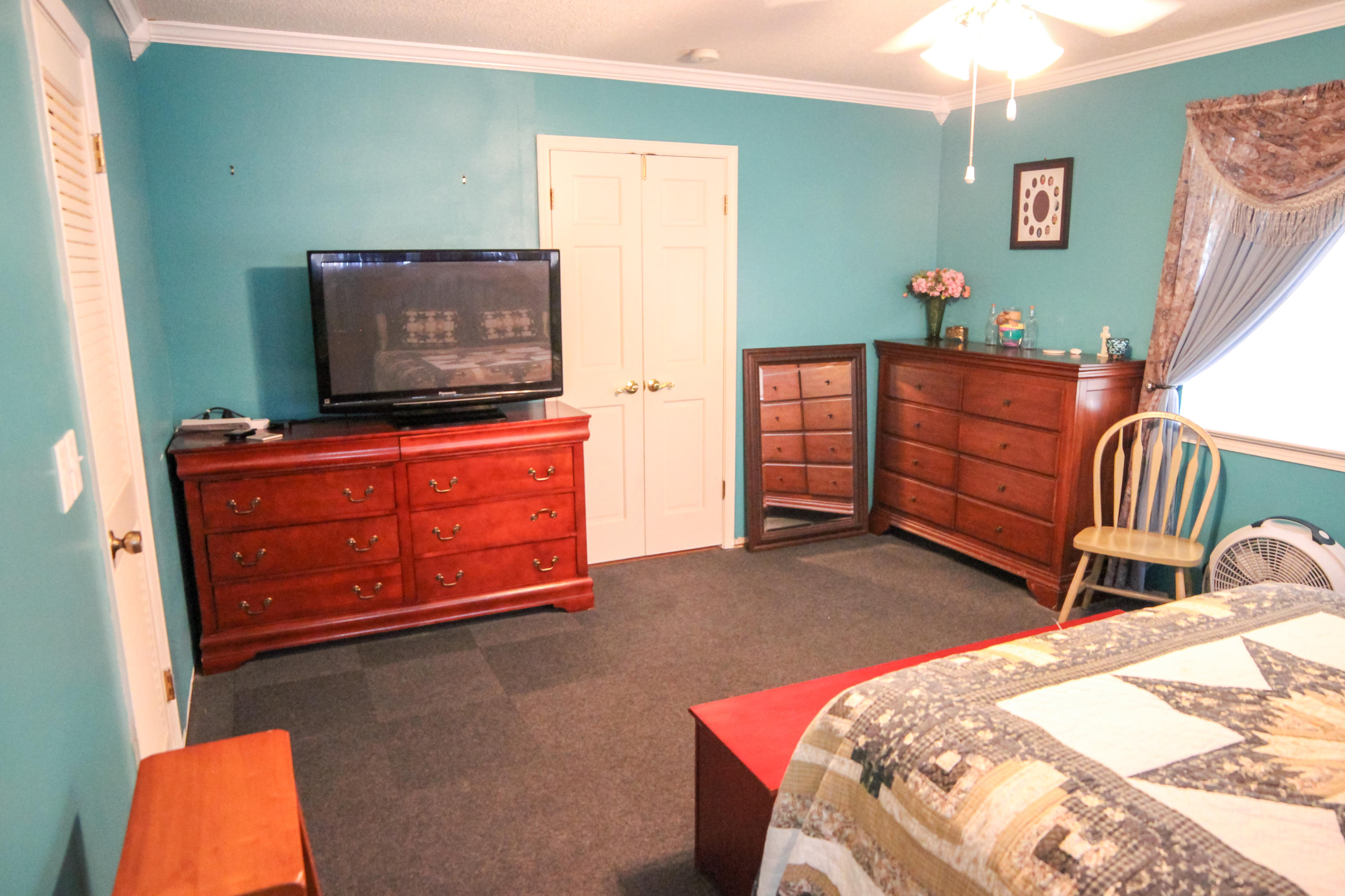 32 Country Club Road Shalimar, FL 32579 - Photo 27 of 56 a bedroom with a bed and tv