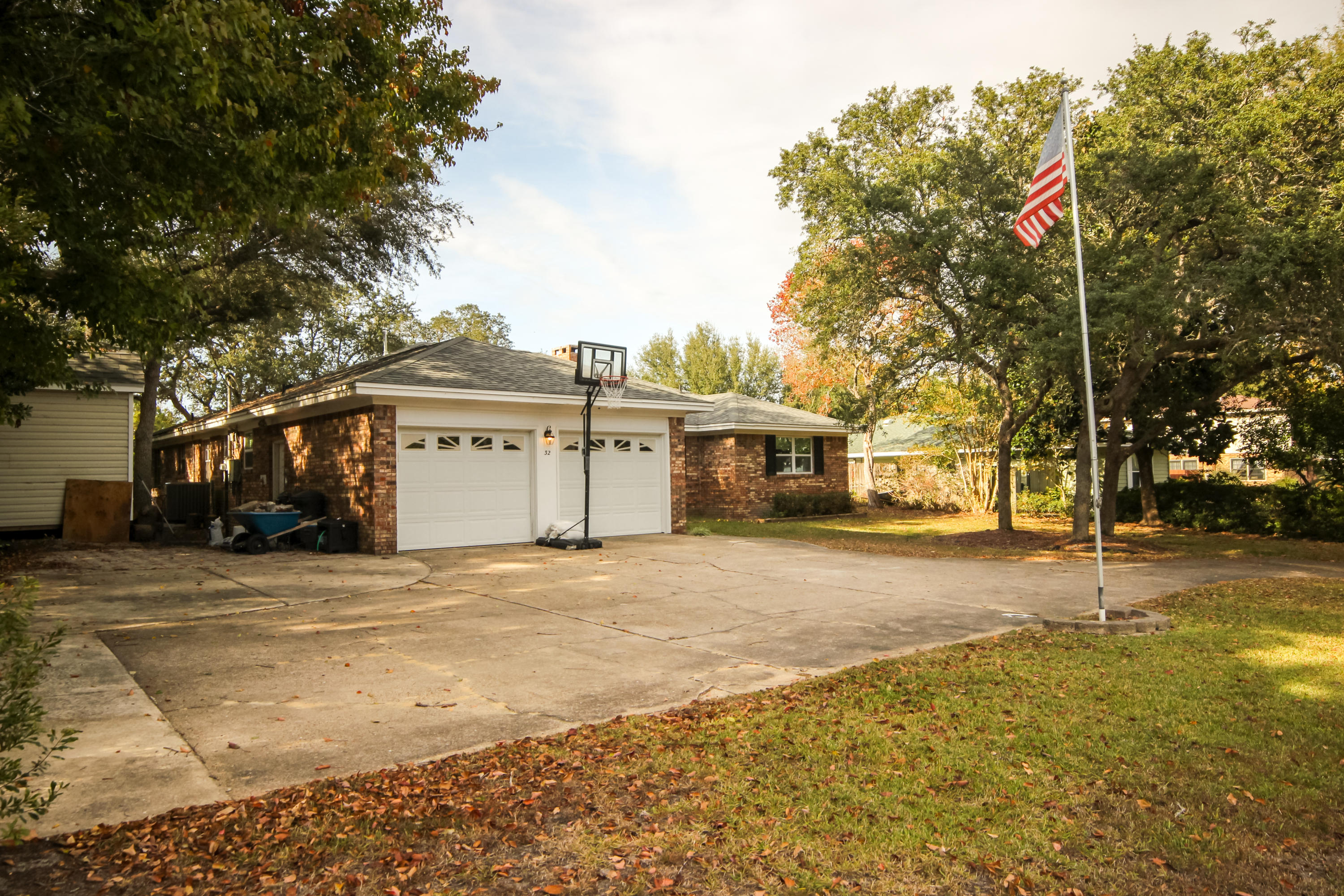 32 Country Club Road Shalimar, FL 32579 - Photo 4 of 56 a front view of a house with a yard and garage