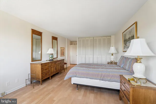 a bedroom with a bed and a dresser in it