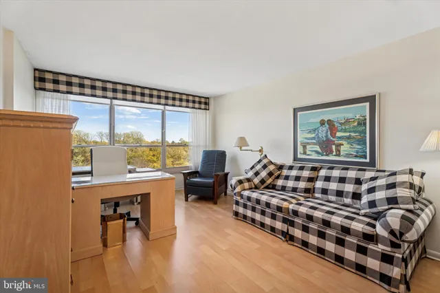 a bedroom with furniture and a large window