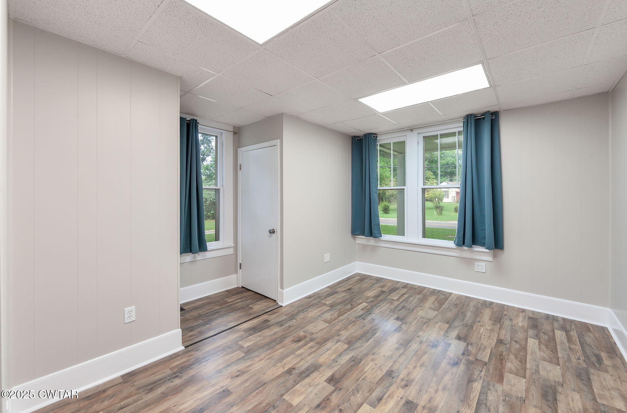 176 Old Denmark Road Jackson, TN 38301 - Photo 11 of 56 an empty room with wooden floor and windows