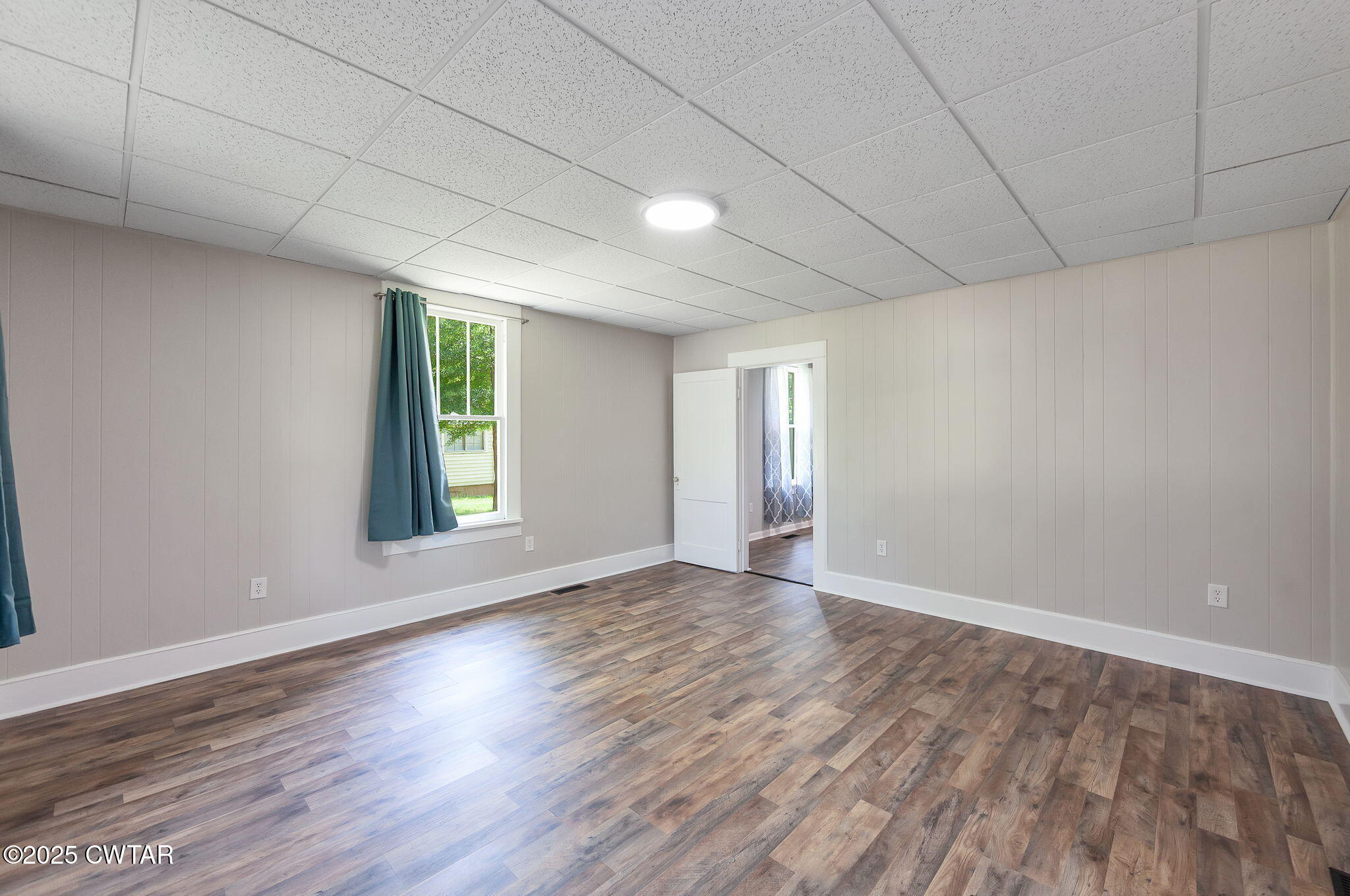 176 Old Denmark Road Jackson, TN 38301 - Photo 8 of 56 a view of an empty room with wooden floor and a window