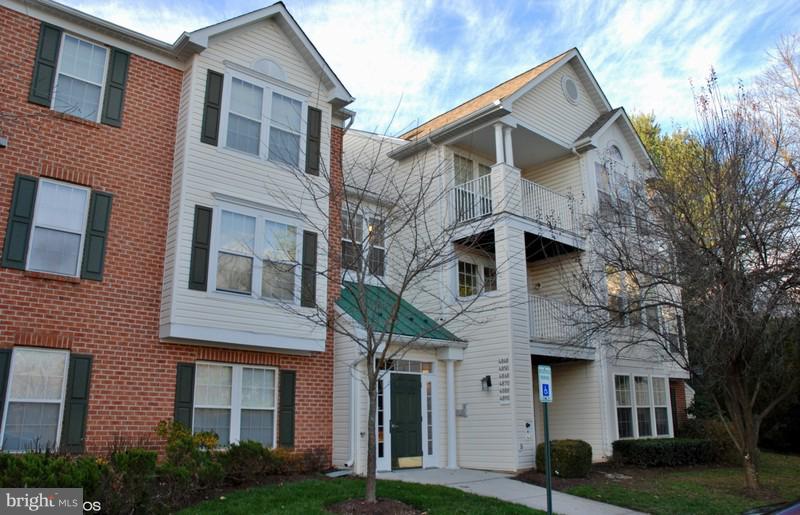 4868 Shellbark Road Owings Mills, MD 21117 - Photo 2 of 23 a view of a white house with large windows and a yard