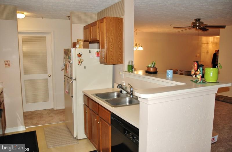 4868 Shellbark Road Owings Mills, MD 21117 - Photo 11 of 23 a kitchen with a sink and refrigerator