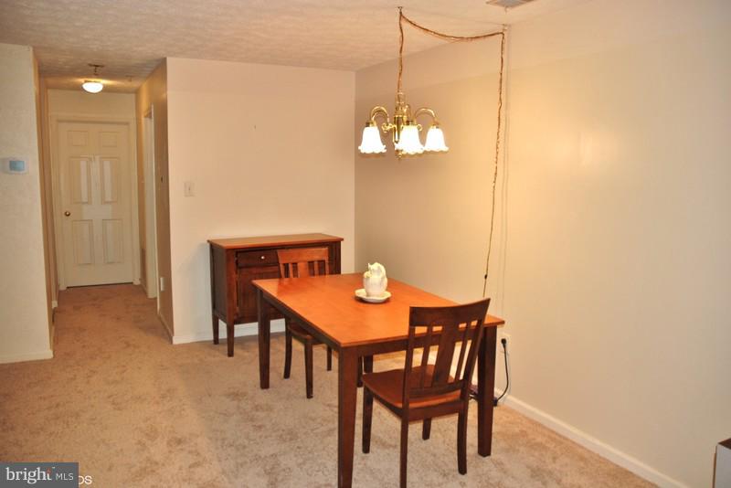 4868 Shellbark Road Owings Mills, MD 21117 - Photo 12 of 23 a view of a dining room with a table and chairs