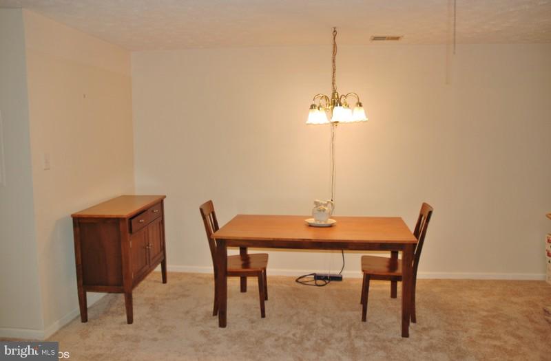 4868 Shellbark Road Owings Mills, MD 21117 - Photo 13 of 23 a view of a dining room with a table and chairs