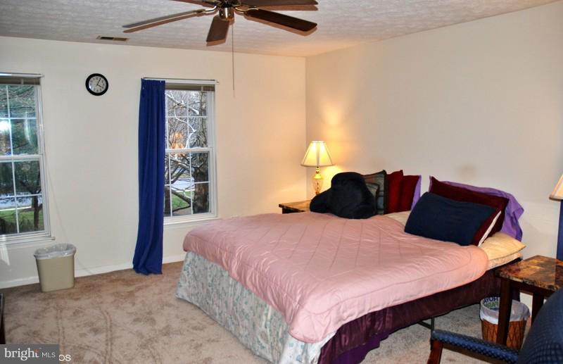 4868 Shellbark Road Owings Mills, MD 21117 - Photo 15 of 23 a bedroom with a bed and a table in it